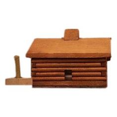 a wooden toy house with a hammer on the floor