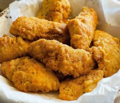 fried chicken in a basket with corn on the side