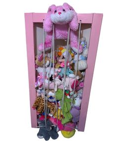 a pink shelf filled with lots of stuffed animals