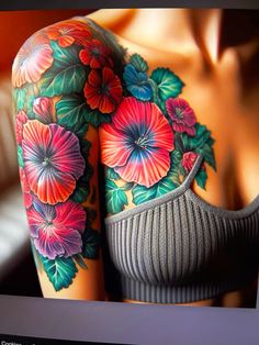 a woman's arm with colorful flowers on it