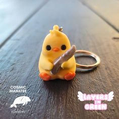 a keychain that has a small yellow bird on it