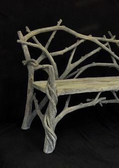 a bench made out of branches on a black background