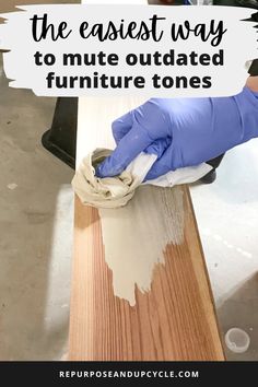 a person in blue gloves wiping paint off the top of a wooden table with text overlay that reads, the easier way to mitts outdated furniture tones