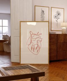 there is a heart drawn on the wall next to a wooden table and some pictures