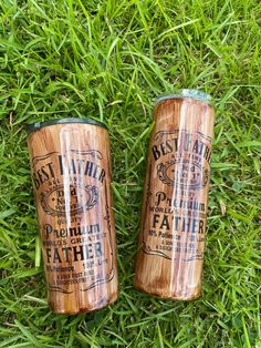 two wooden cups sitting on top of green grass