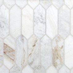 a white marble mosaic tile pattern with brown and beige accents on the bottom half of it