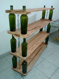 three wooden shelves with green glass bottles on them