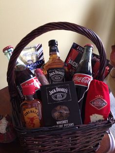 a wicker basket filled with liquor and snacks