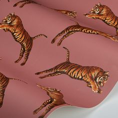 a pink wallpaper with tiger images on it