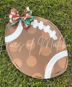 a football painted on the grass with a bow