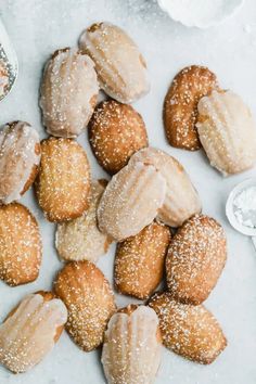 doughnuts with sugar sprinkled on them and bowls of powdered sugar