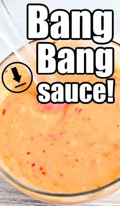 an orange sauce in a glass with the words bang bang sauce