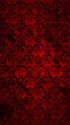 a red wallpaper with black and white designs on it's surface, as well as the background