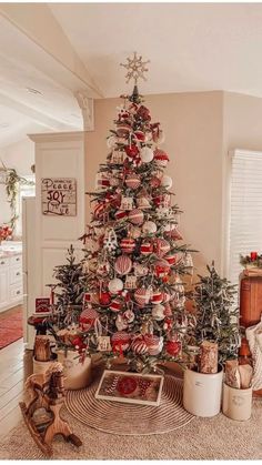 a decorated christmas tree in a living room with ornaments on the top and around it