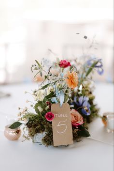 Low wildflower style wedding centerpiece Wild Flower Centerpieces Rustic, Wildflower Wedding Center Piece, Whimsical Wedding Centerpiece Floral Arrangements, Small Wildflower Centerpieces, Wild Flower Centerpieces Wedding Round Table, Fall Wedding Wild Flowers, Ranunculus Centerpiece Wedding, Wild Flower Centerpiece Round Table, Wild Flower Wedding Centerpiece