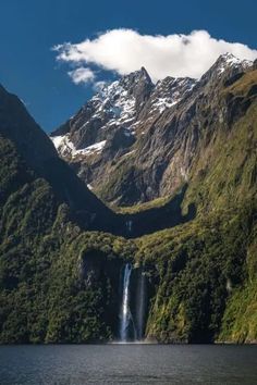 a large waterfall in the middle of a mountain range