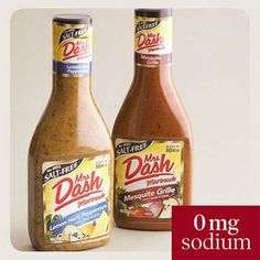 two bottles of dressing sitting next to each other on a white surface with the words dash written in red