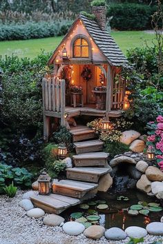 a small house with steps leading up to it and lit candles in the front window