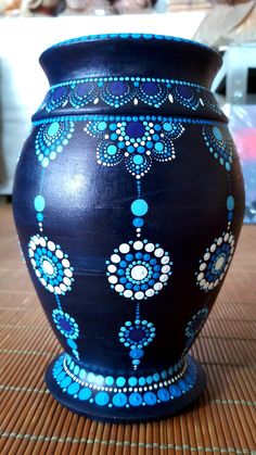 a blue vase sitting on top of a wooden table