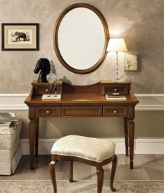 a dressing table with a mirror and stool