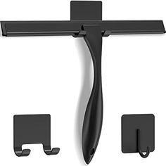 a black wall mounted shelf with two hooks