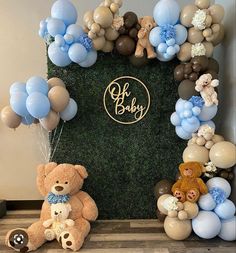 a teddy bear and balloon arch for a baby shower