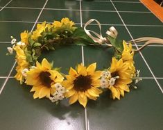 a sunflower wreath is laying on the floor