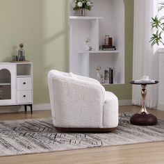 a living room with white furniture and green walls