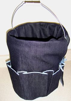 a black bucket bag sitting on top of a white counter next to a wall and floor