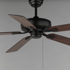 a black ceiling fan with three wooden blades