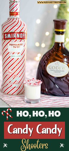 a bottle of candy cane syrup next to a glass with whipped cream and peppermint on it