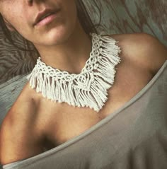 a close up of a person wearing a necklace