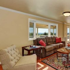 a living room with two couches and a coffee table in front of a large window