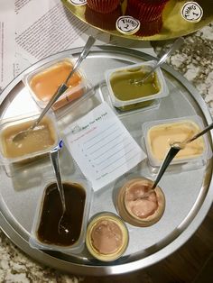 an assortment of sauces and condiments are arranged on a silver platter