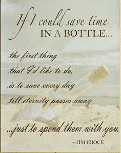 a message written in sand with an empty bottle