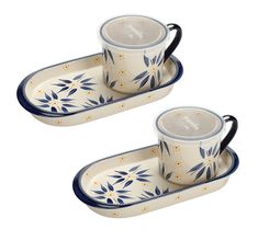 two blue and white ceramic serving dishes with handles, one holding a coffee cup and the other carrying a saucer