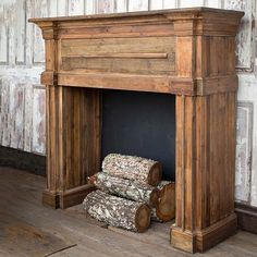 an old fireplace with logs stacked on top