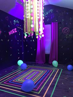 the room is decorated with neon lights and balloons