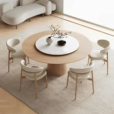 a round table with white chairs around it