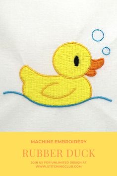 a yellow rubber duck with bubbles in it's mouth on a white fabric background