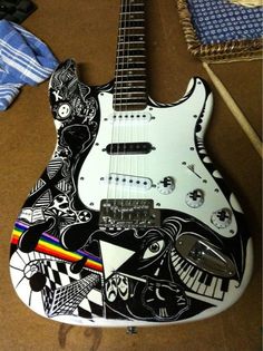 a white guitar with black and white designs on it