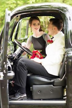 a man and woman sitting in the driver's seat of a truck