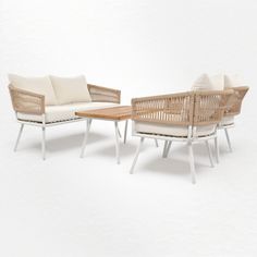 three wicker chairs and a coffee table with cushions on white background, side by side