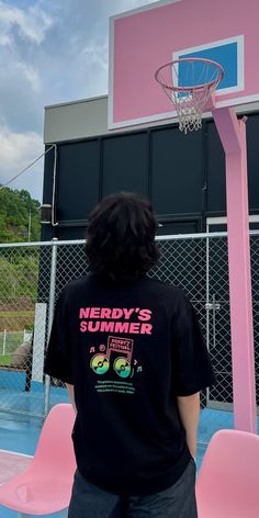 a person standing in front of a pink basketball hoop