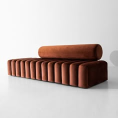 an orange couch sitting on top of a white floor next to a heart shaped object