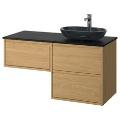 a bathroom vanity with a bowl sink and black counter top