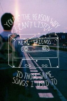 a person standing next to a road with the words, you're the reason why i can't listen