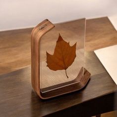 a book with a leaf in it sitting on top of a table