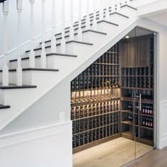 a wine cellar under the stairs in a home