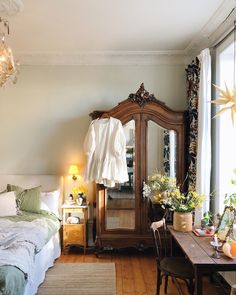 a bedroom with a bed, dresser and mirror in it's centerpieces